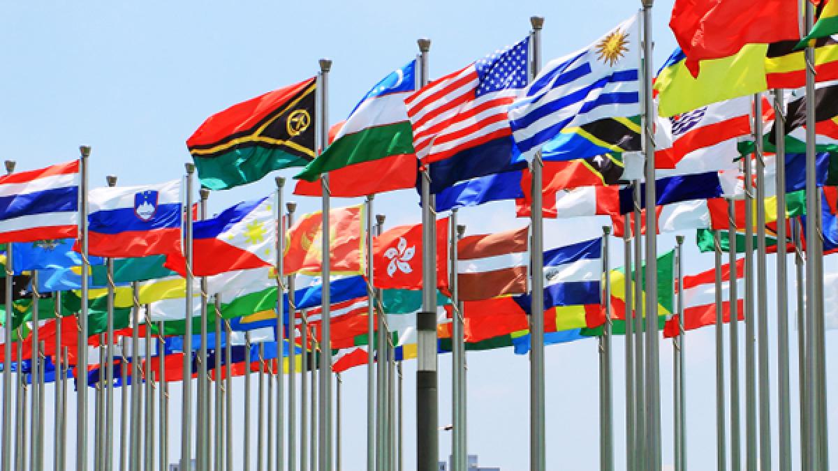 Security personnel in front of a map of the world